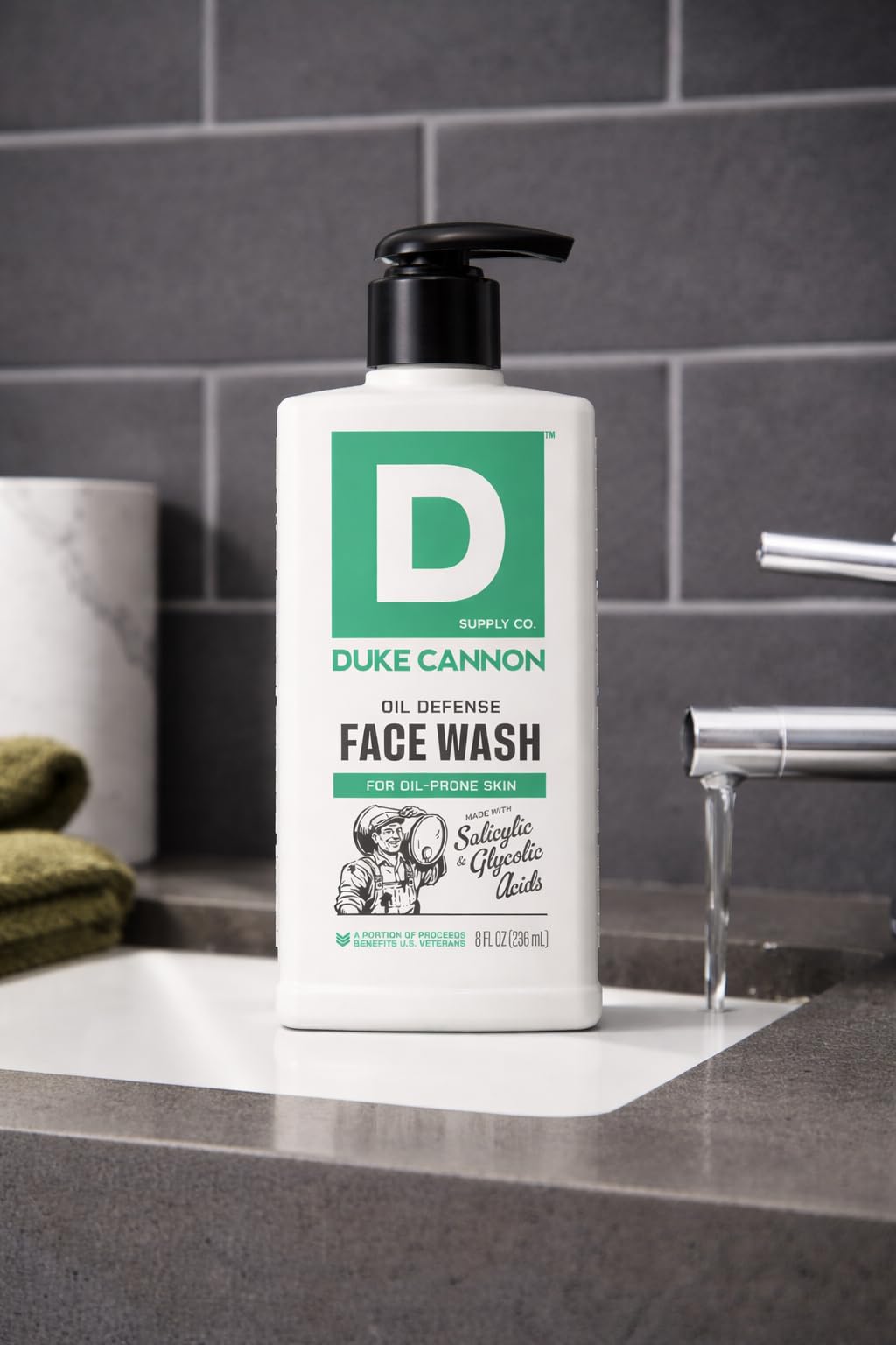 Duke Cannon face wash next to towel in bathroom, illustrating daily routine benefit