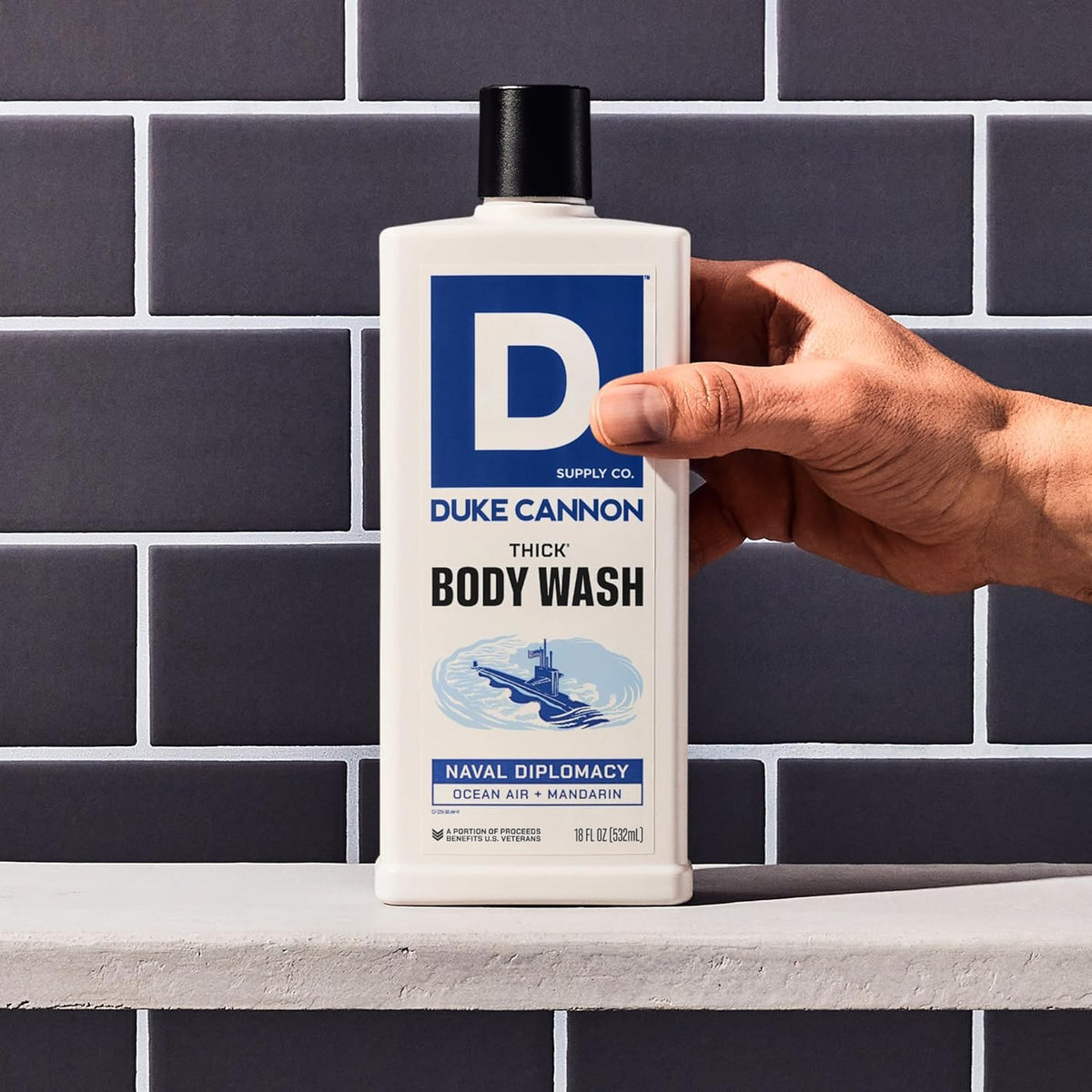 Duke Cannon lather on loofah in hand showing rich foam and improved cleansing