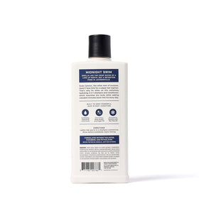 Duke Cannon bottle on bathroom counter styled with grooming items, suggesting complete routine benefit