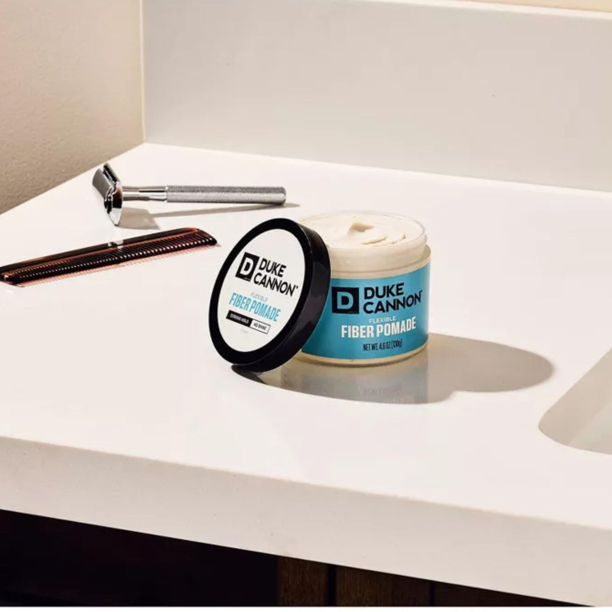 Duke Cannon pomade jar next to ruler showing 4.6 oz size for scale