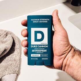 3 oz Duke Cannon Seawolf next to travel items showing compact grooming convenience