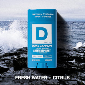 Duke Cannon next to a smartphone to show compact size