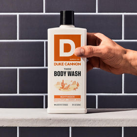 Duke Cannon body wash in use in shower showing thorough dirt removal benefit
