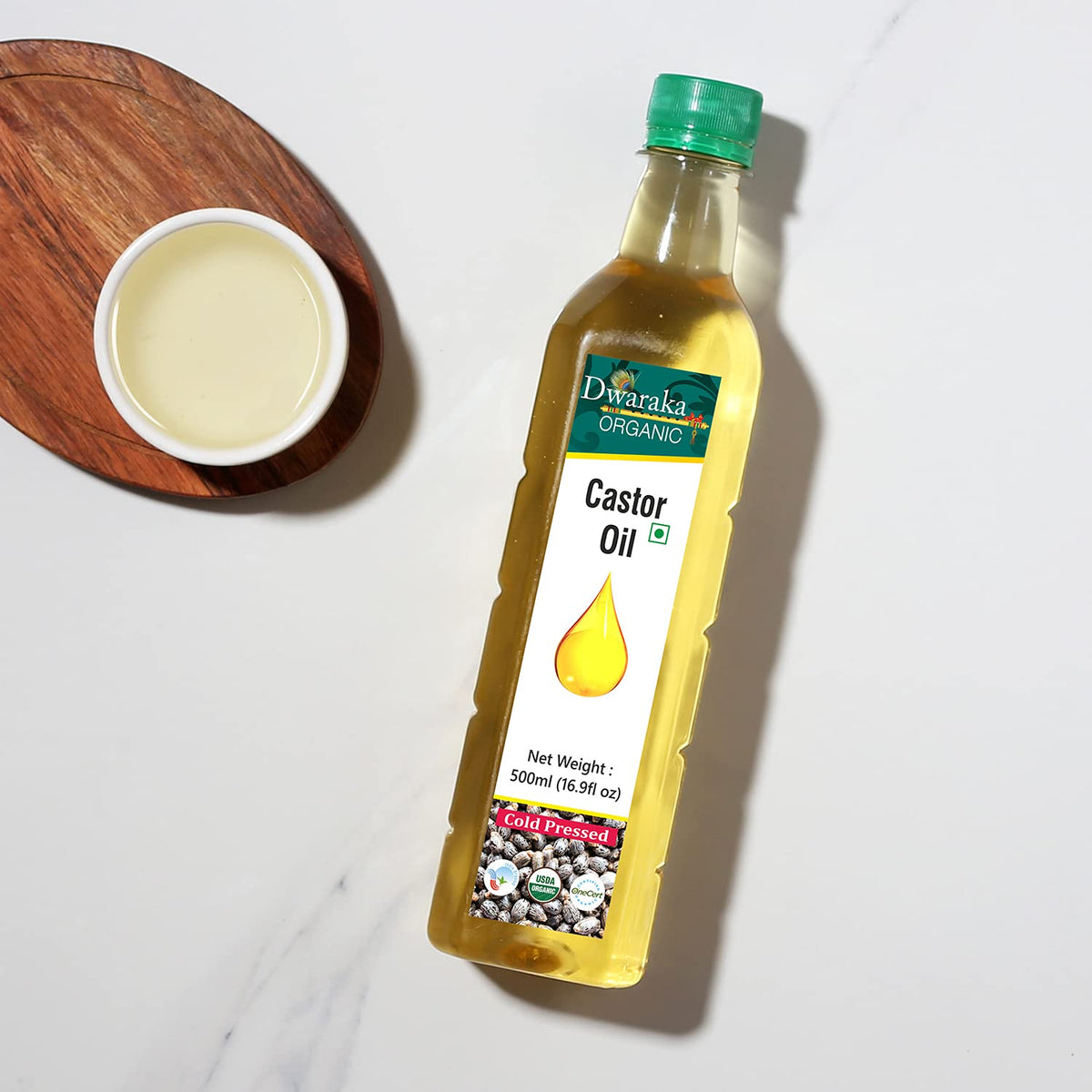 Model applying Dwaraka castor oil to hair roots for improved manageability and strength