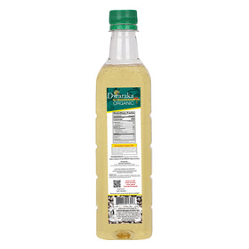 Close-up of Dwaraka castor oil pouring to show smooth texture and nutrient retention