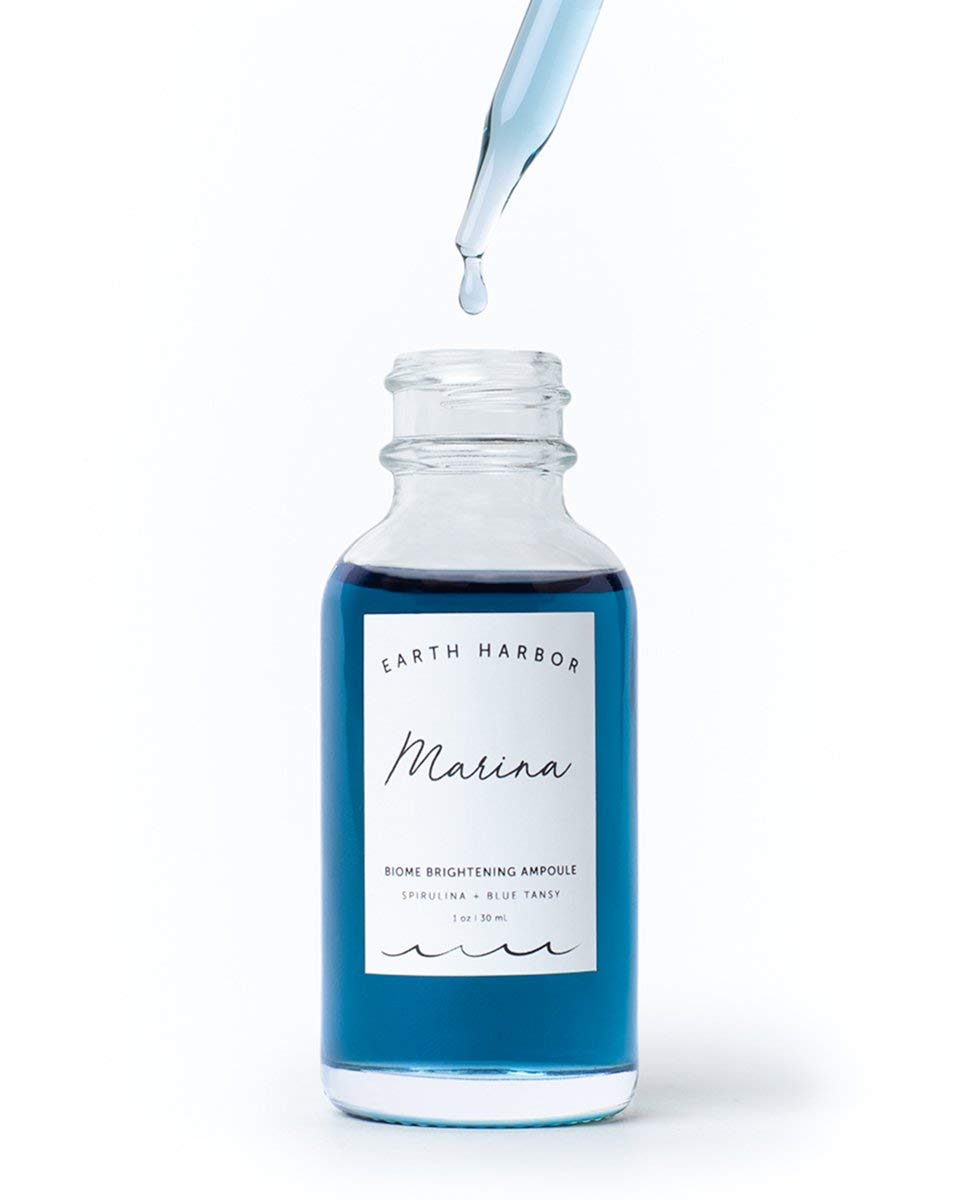 Earth Harbor MARINA ampoule dropper releasing serum, demonstrating controlled, hygienic application