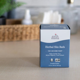 Earth Mama sachet in hand to show size and single-use convenience benefit