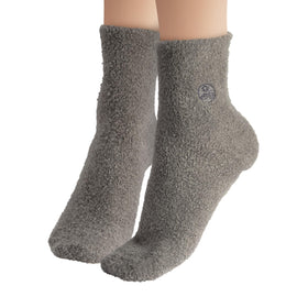 Earth Therapeutics socks beside a ruler for size comparison and one-size-fit demonstration