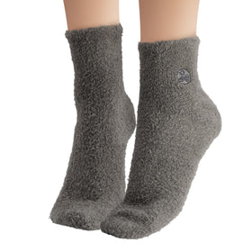 Earth Therapeutics socks worn on feet demonstrating cushioned comfort and lotion retention