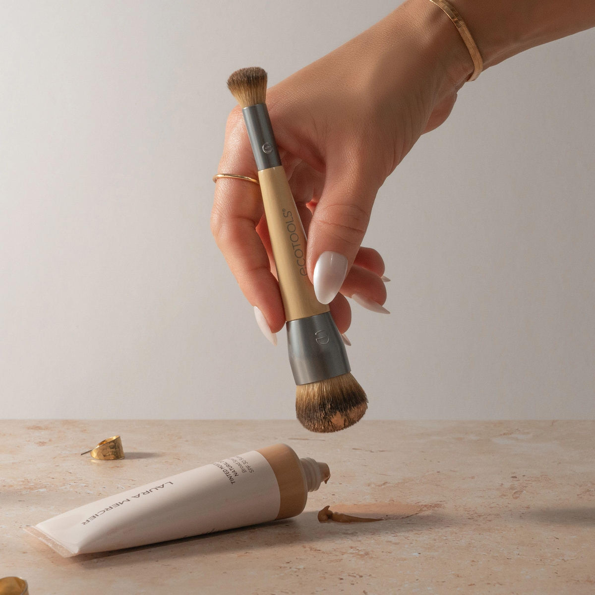 EcoTools brush being rinsed with cleanser to show easy maintenance
