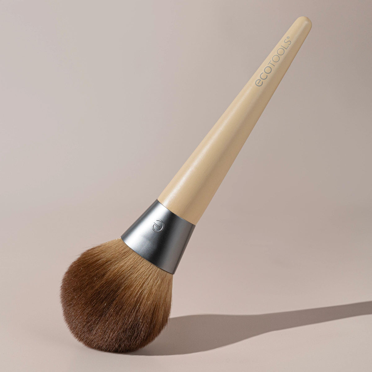 EcoTools brush being cleaned with brush shampoo to maintain softness and performance