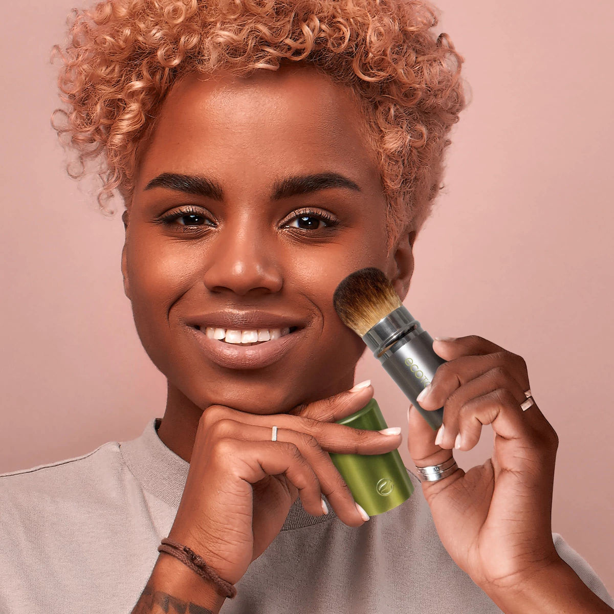 EcoTools brush tucked in a purse for on-the-go touch-ups and convenient portability