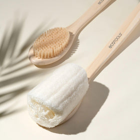 EcoTools brush in shower being used to clean back and hard-to-reach areas