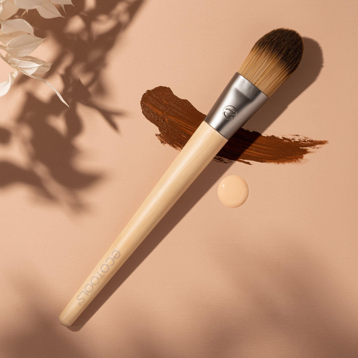 EcoTools brush applying liquid foundation for even skin coverage