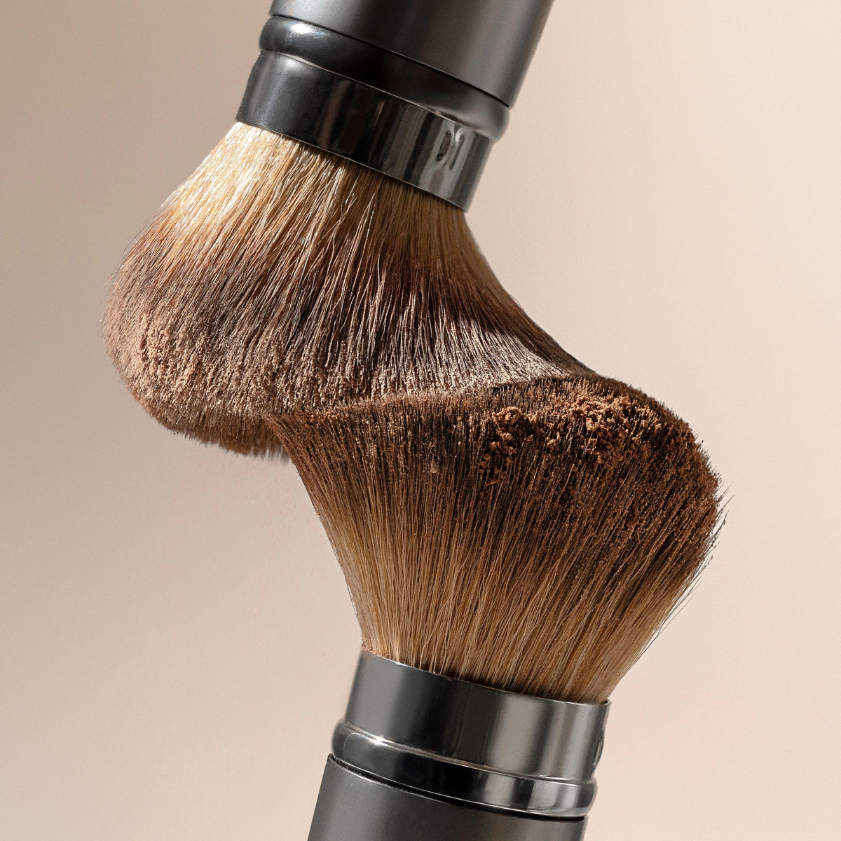 EcoTools brush being cleaned with shampoo for maintained performance and longer life