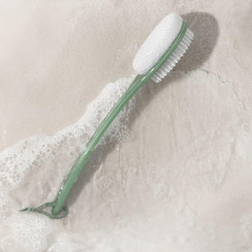 EcoTools Sea Gems brush in shower demonstrating long-handle reach to back