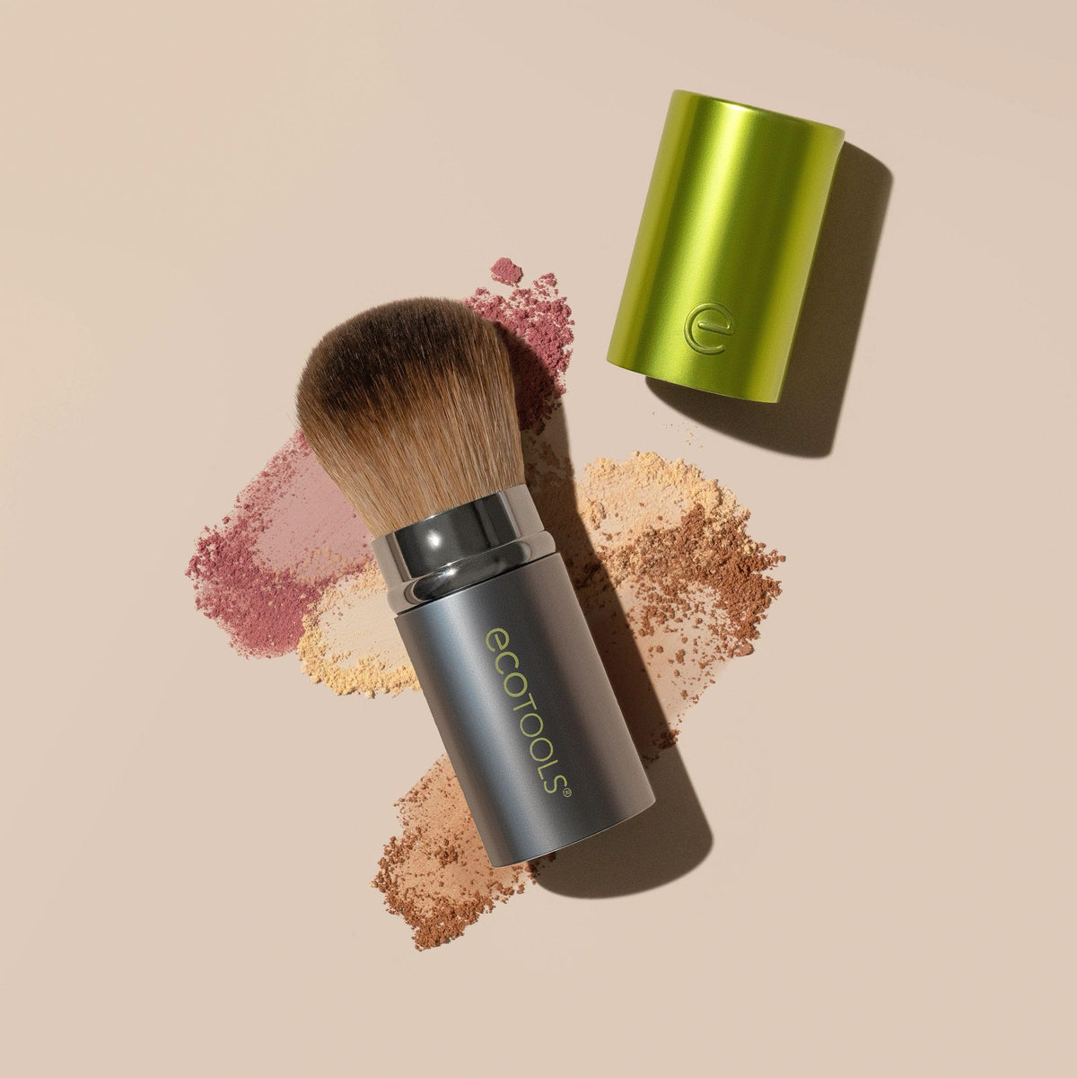 EcoTools brush next to a coin showing compact size and easy travel convenience