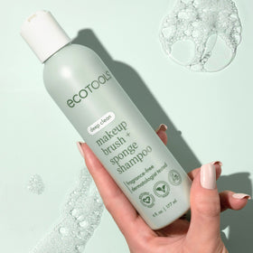EcoTools bottle next to hand showing 8 fl oz size and portability benefit