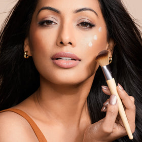 EcoTools brush applying blush to cheek showing precise placement and natural finish