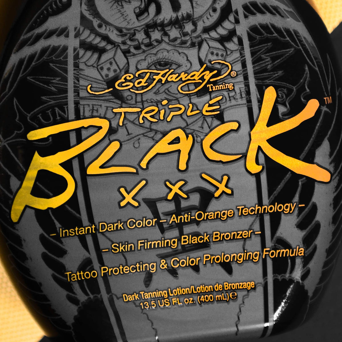 Ed Hardy BLACK XXX applied on model showing deep immediate bronzing and tattoo protection
