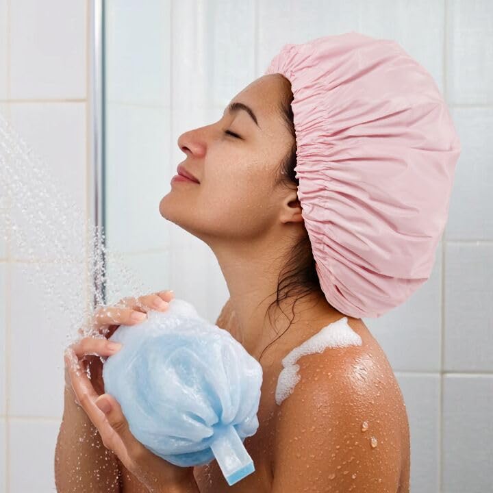 Edoneery shower cap worn over long braids keeping hair dry during shower