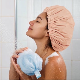 Edoneery cap held in hand to show scale and roomy fit for long hair