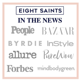 Eight Saints 1oz bottle next to a coin conveying compact travel-friendly size and portability