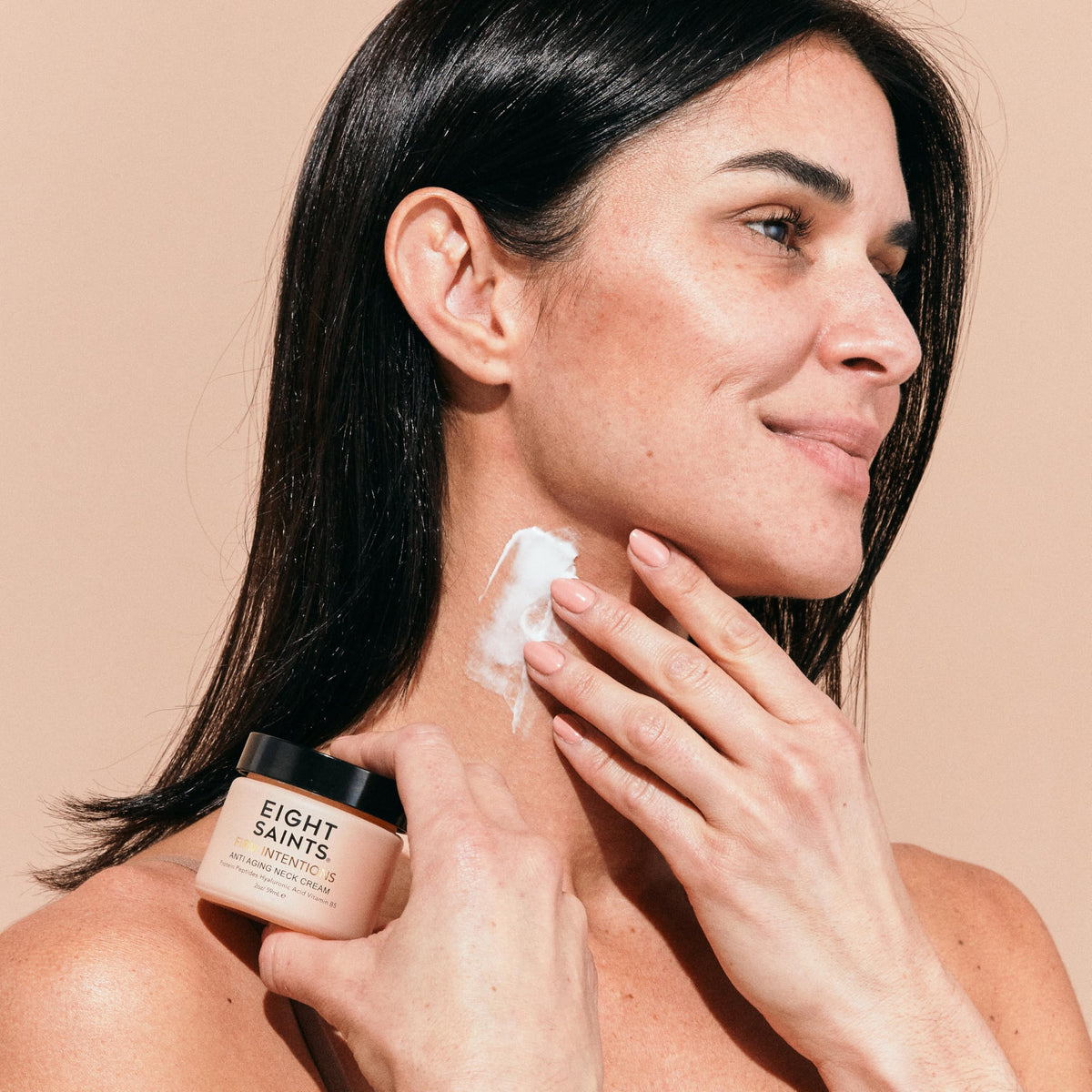 Eight Saints being applied to neck demonstrating firming routine benefit