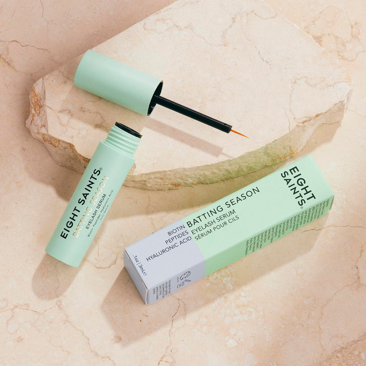 Eight Saints applying serum to upper lash line illustrating simple daily use and coverage