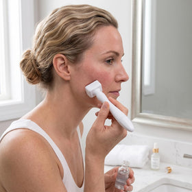 EIVSMCZ derma stamp in use on cheek demonstrating targeted application and improved product absorption