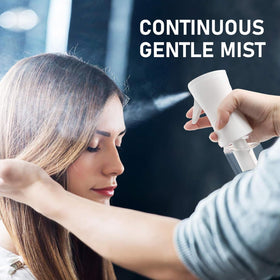 ELEMSY spraying fine mist on hair demonstrating even coverage and styling benefit