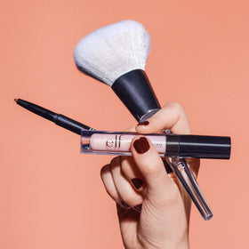 e.l.f. Precision Airbrush Blender held in hand demonstrating ergonomic triangular handle control