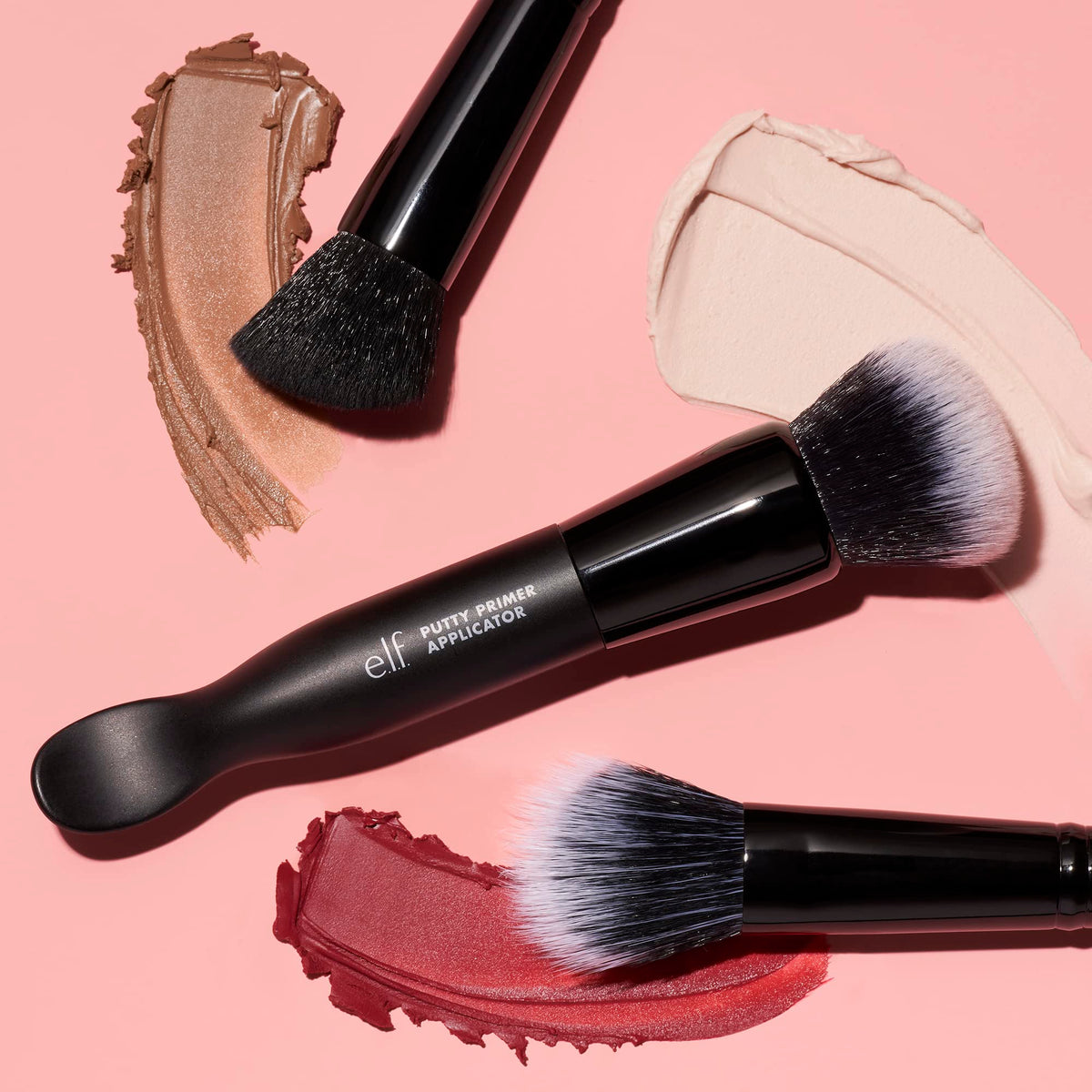 e.l.f. bronzer brush next to a makeup pan to show size and buffing control