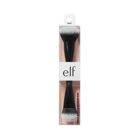 e.l.f. brush held in hand for scale showing travel-friendly compact size