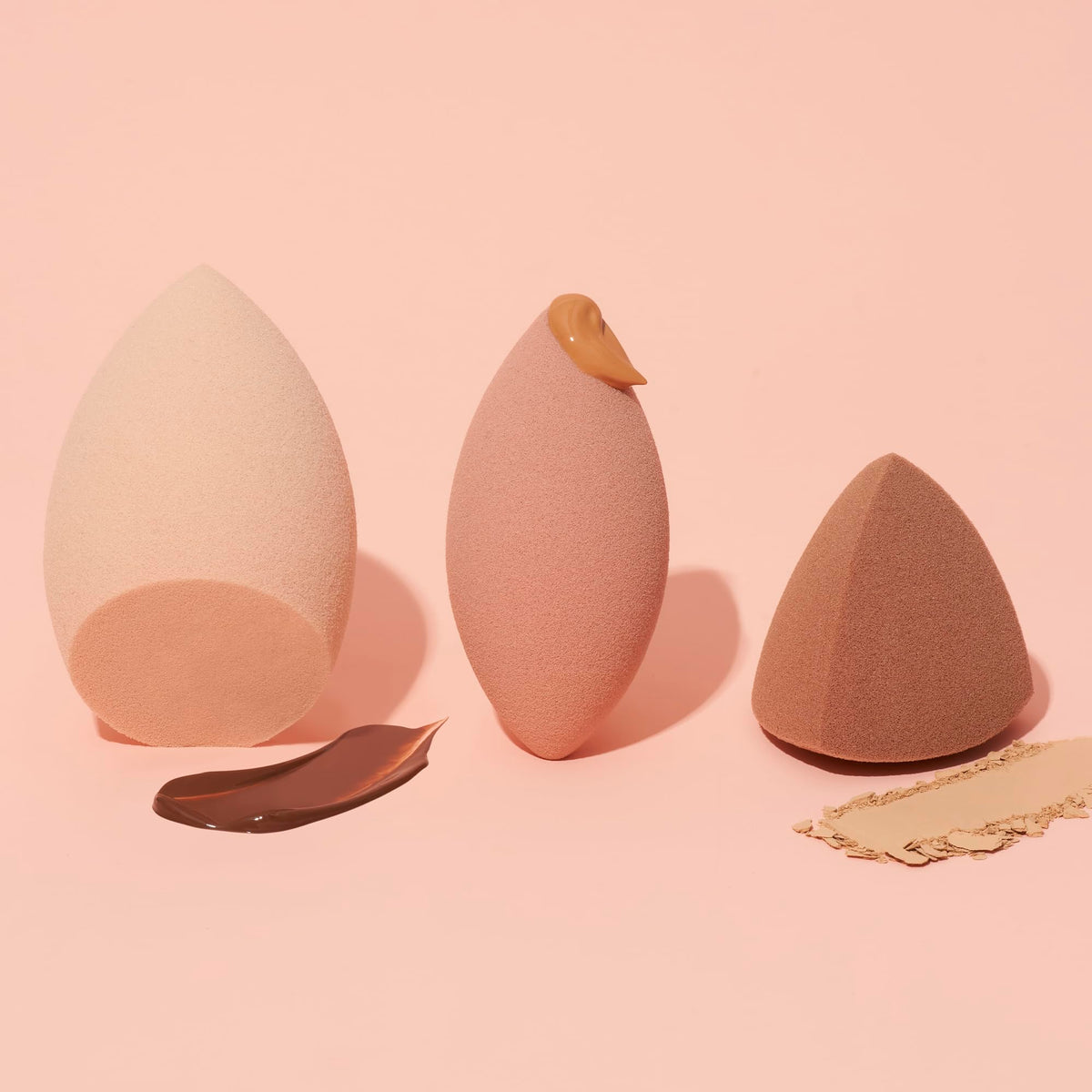 e.l.f. sponges in use blending foundation for streak-free, seamless skin finish