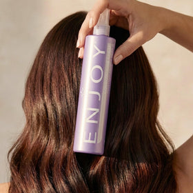Enjoy conditioning spray on bathroom vanity in lifestyle scene for everyday hair care benefit