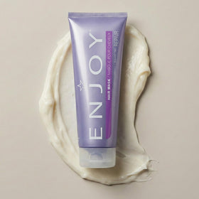 Enjoy hair mask next to a ruler showing the 8 oz size and portability
