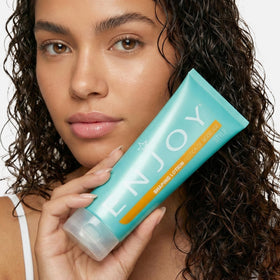 Enjoy shaping lotion styled on bathroom shelf with towel showing everyday grooming convenience