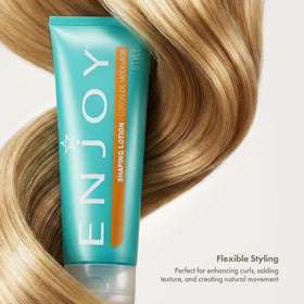 Enjoy shaping lotion applied to curly hair showing enhanced curl definition and soft movement