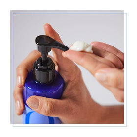 Hand holding EO French Lavender bottle to show dispensing and control for massage