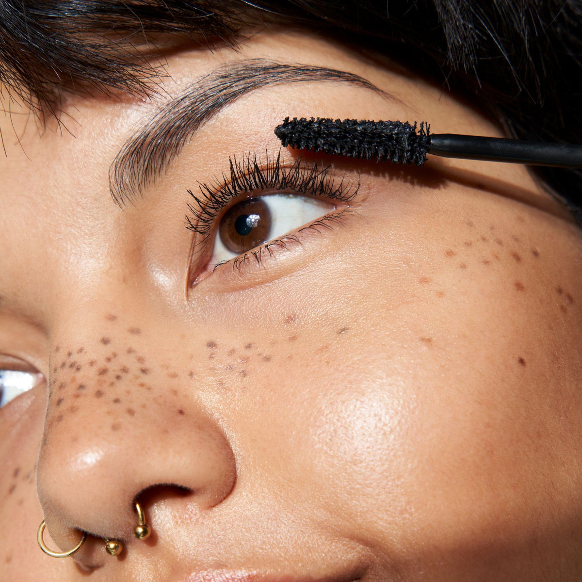 essence on model full face view showcasing lifted, dramatic lashes