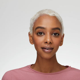 essence model applying gloss to lips for instant volume and high shine