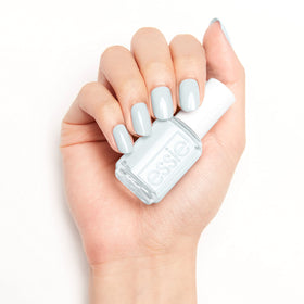 essie bottle paired with cuticle oil suggesting complete manicure routine