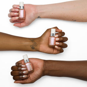 essie swatch on nail tip showing peach holographic shift and wearable sparkle