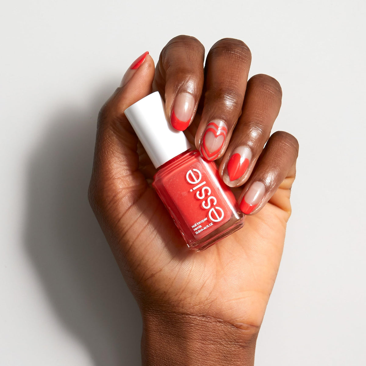 essie bottle beside coin for size comparison and travel-friendly benefit