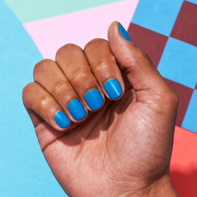 essie swatch on fingers showing finished manicure and vibrant offbeat chic color