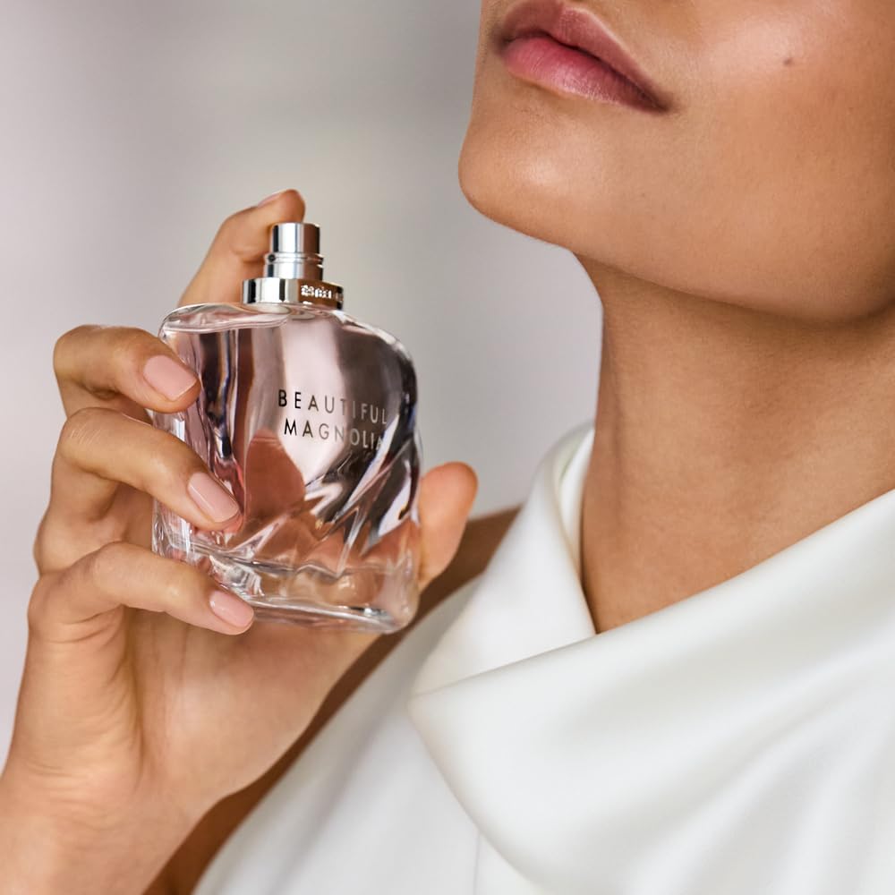 Estée Lauder bottle tucked inside a purse showing Beautiful Magnolia easy everyday carry