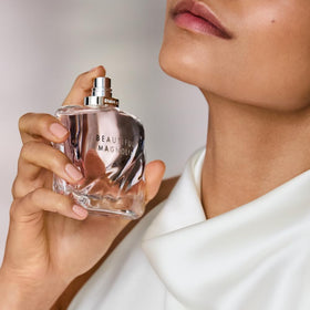 Estée Lauder bottle tucked inside a purse showing Beautiful Magnolia easy everyday carry