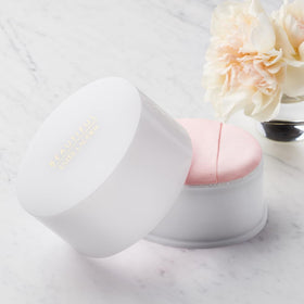Estée Lauder powder texture close-up revealing silky, lightly shimmering finish
