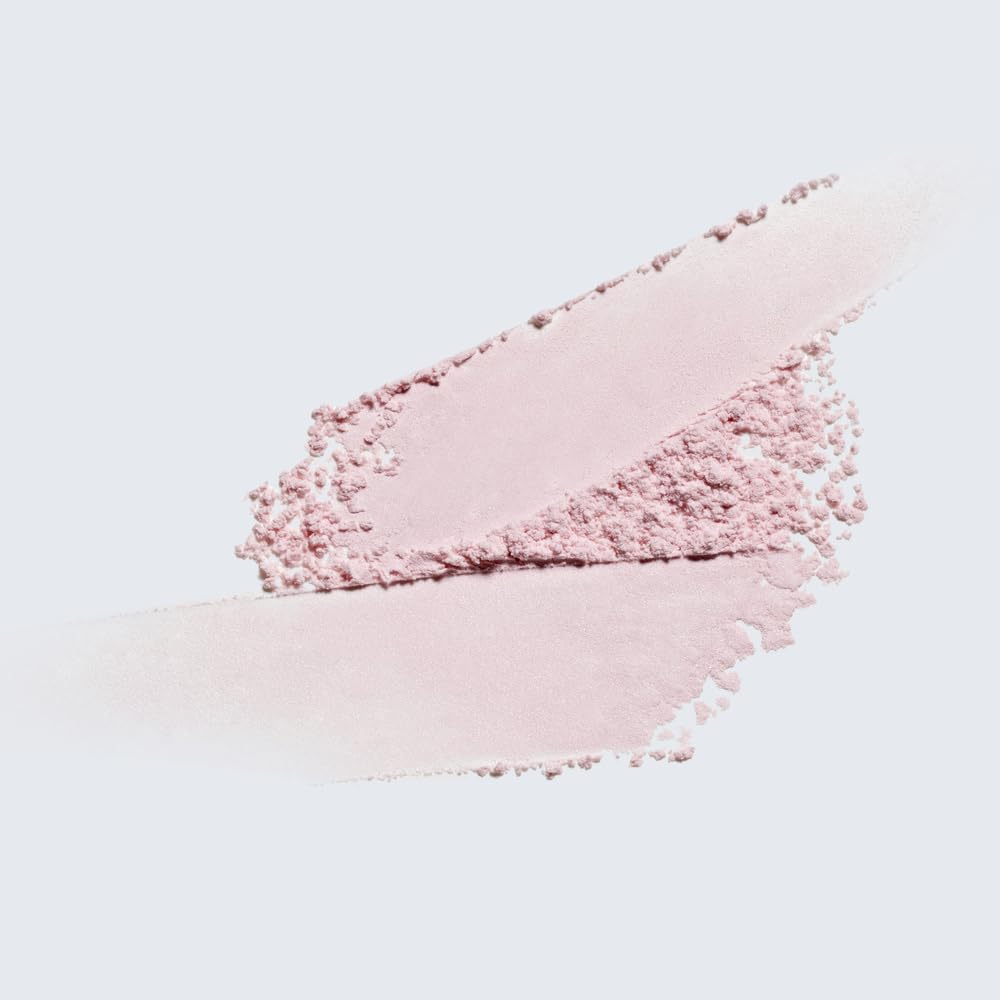 Estée Lauder powder jar in hand for size perspective and easy portability